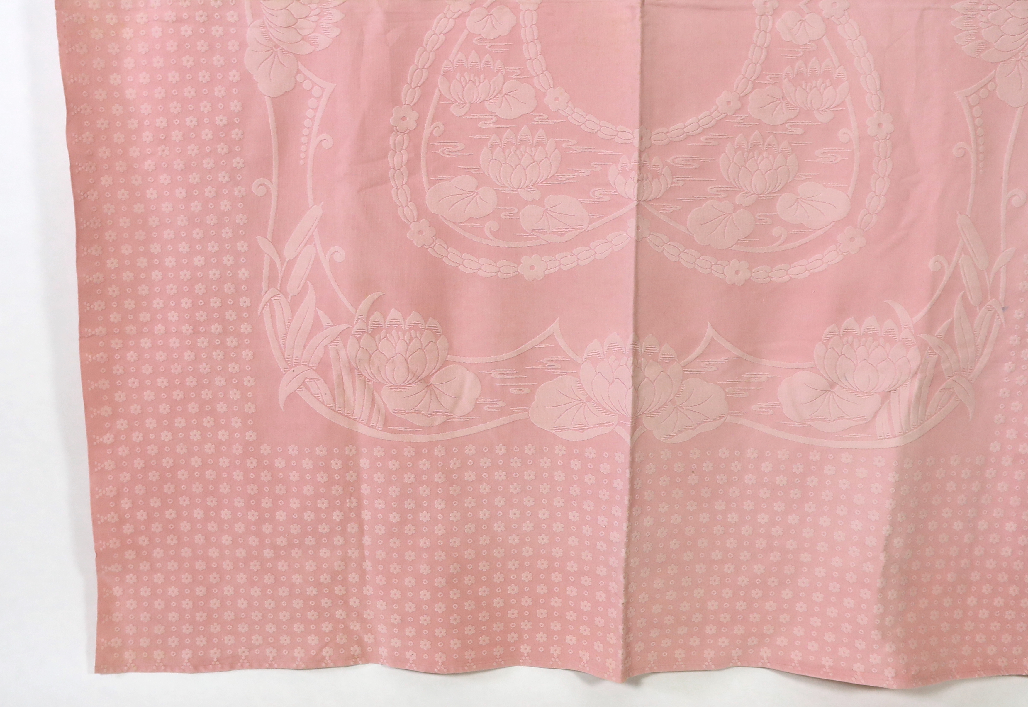 An early 20th century pink lily pad and bull rush designed woven ‘Marcella’ bedspread, 192cm wide, 228cm long